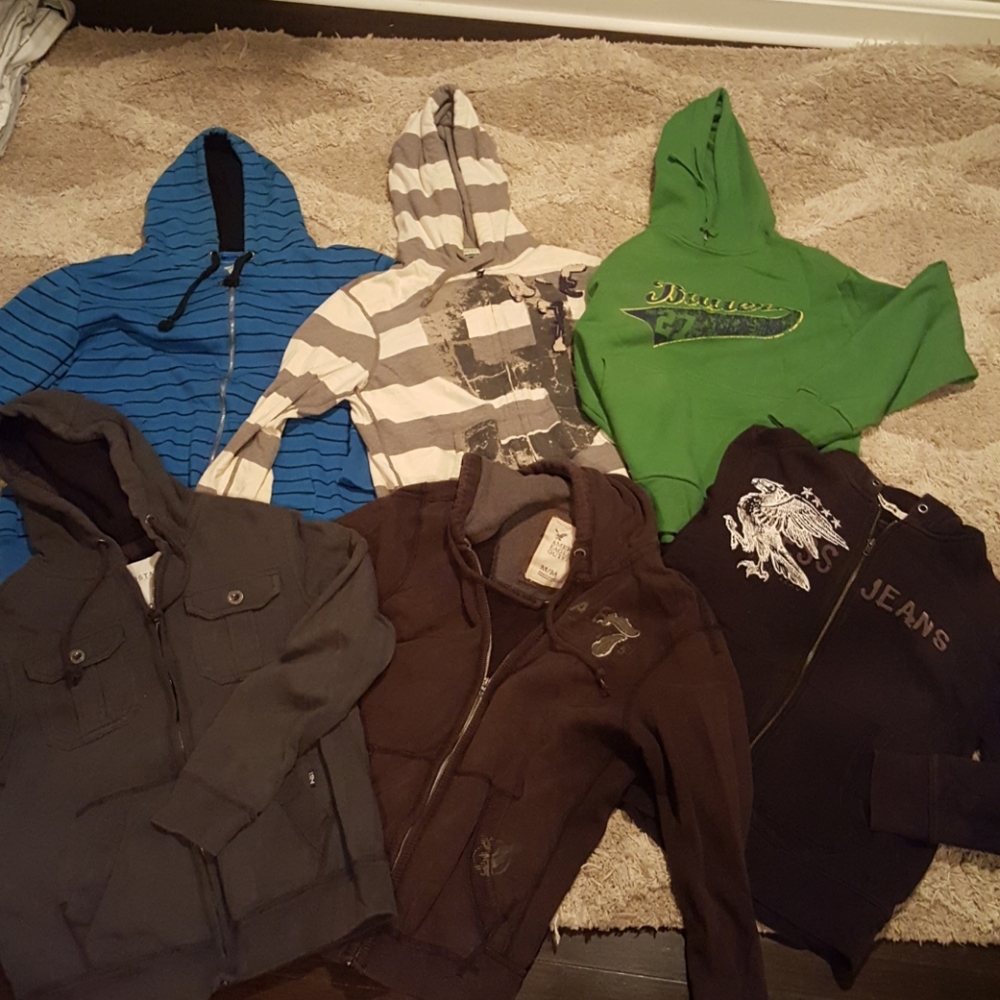 Lot of men's zip ups and hoodies.